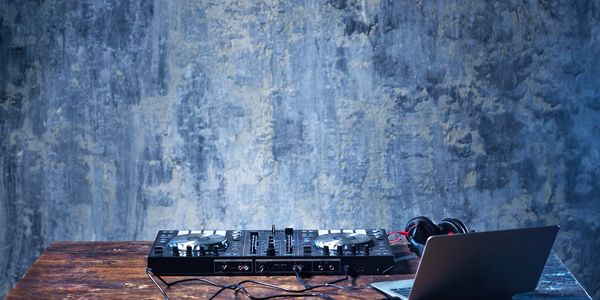 DJ equipment and a laptop on a table