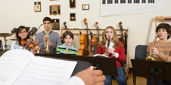 Group of people learning music instruments