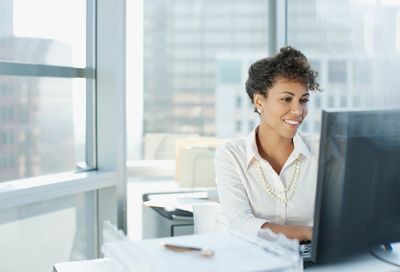 A person using a computer in an office.