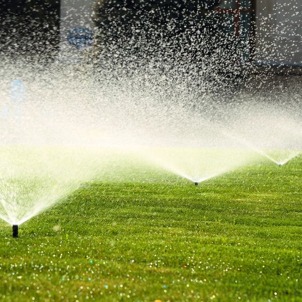 Open sprinklers on grass