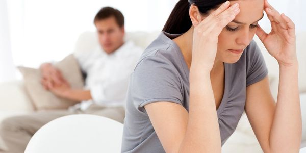 Picture of a woman appearing stressed and disconnected from others