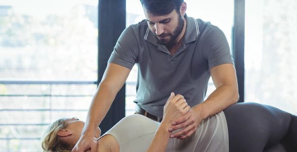 Massage therapist performing a assisted stretch on a massage therapy client.