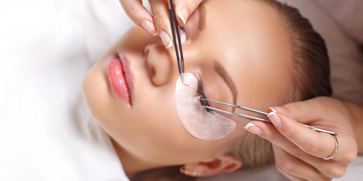 Woman getting eyelash extensions