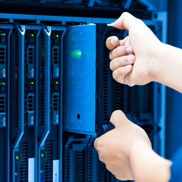 Person installing a hard drive in a server rack.