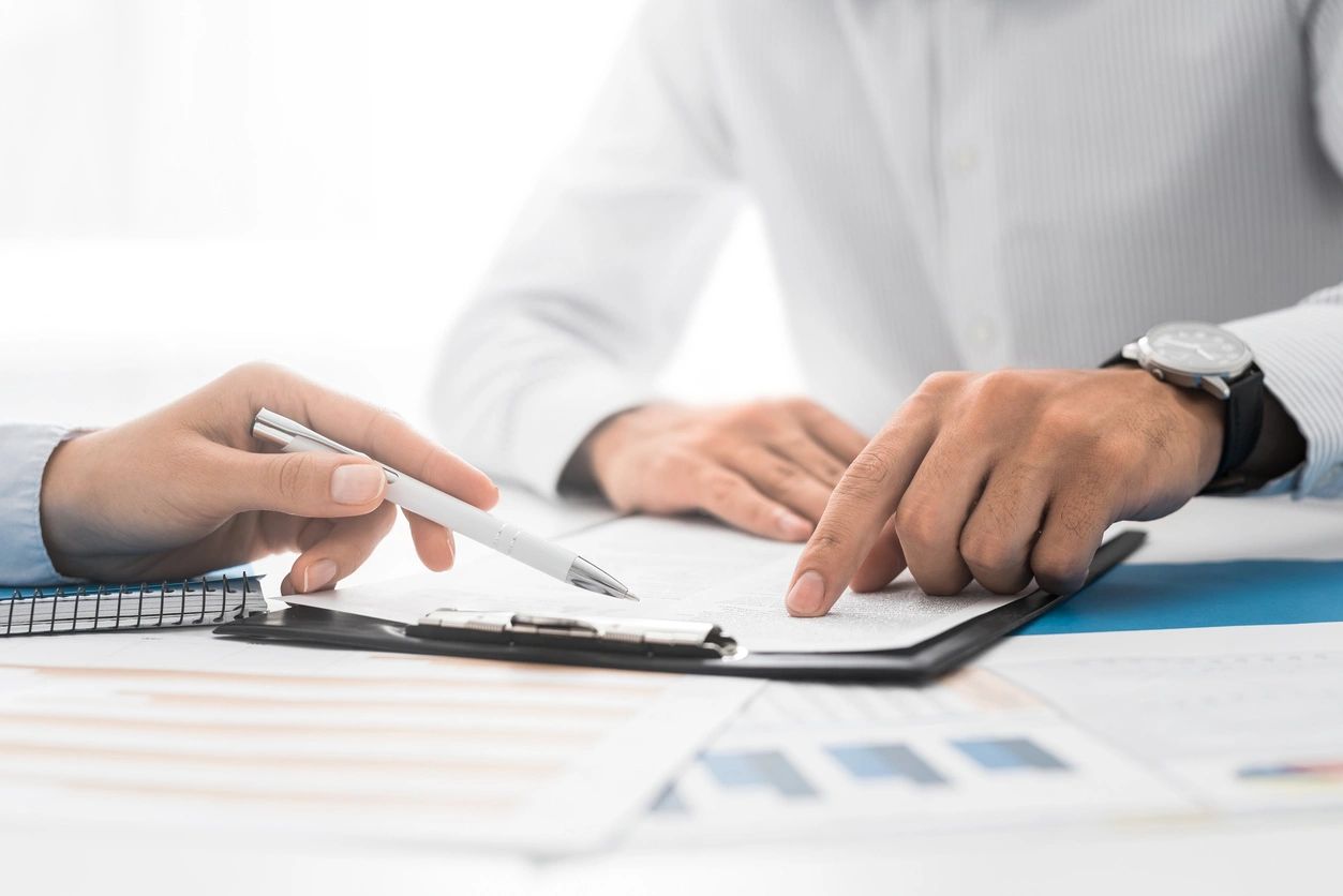 Close up of hands holding a Clipboard and pen 