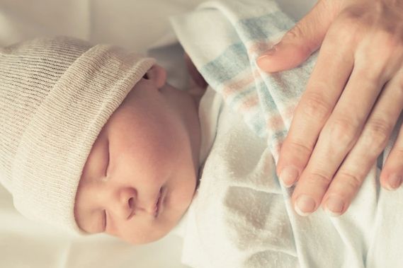 newborn baby with hand