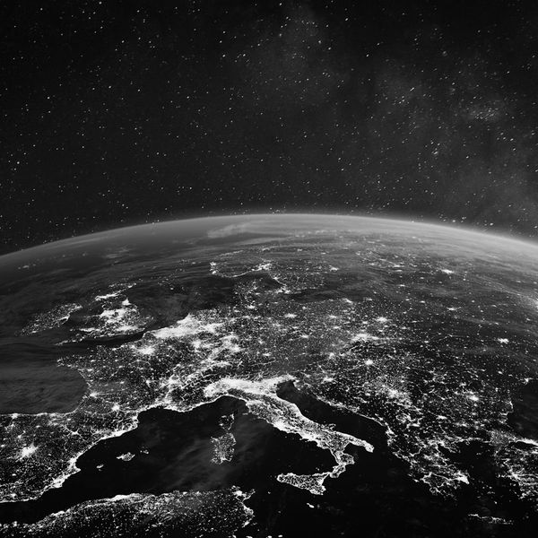 Black and white satellite view of Europe at night.