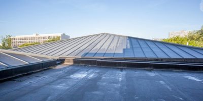 Image of the roof top of a residential building showing the flat rubber roof