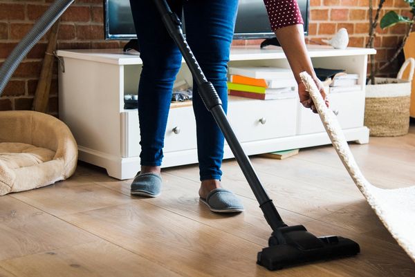 Woman cleaning a Carpet.