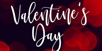Elegant Valentine's Day text with red bokeh background.