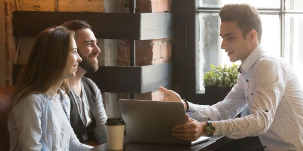 Insurance consultant talking with his clients