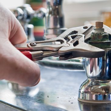 He's fixing a stem washer on a faucet repair