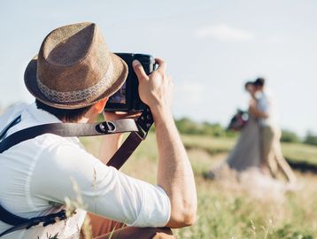 Photographer taking a picture of a couple