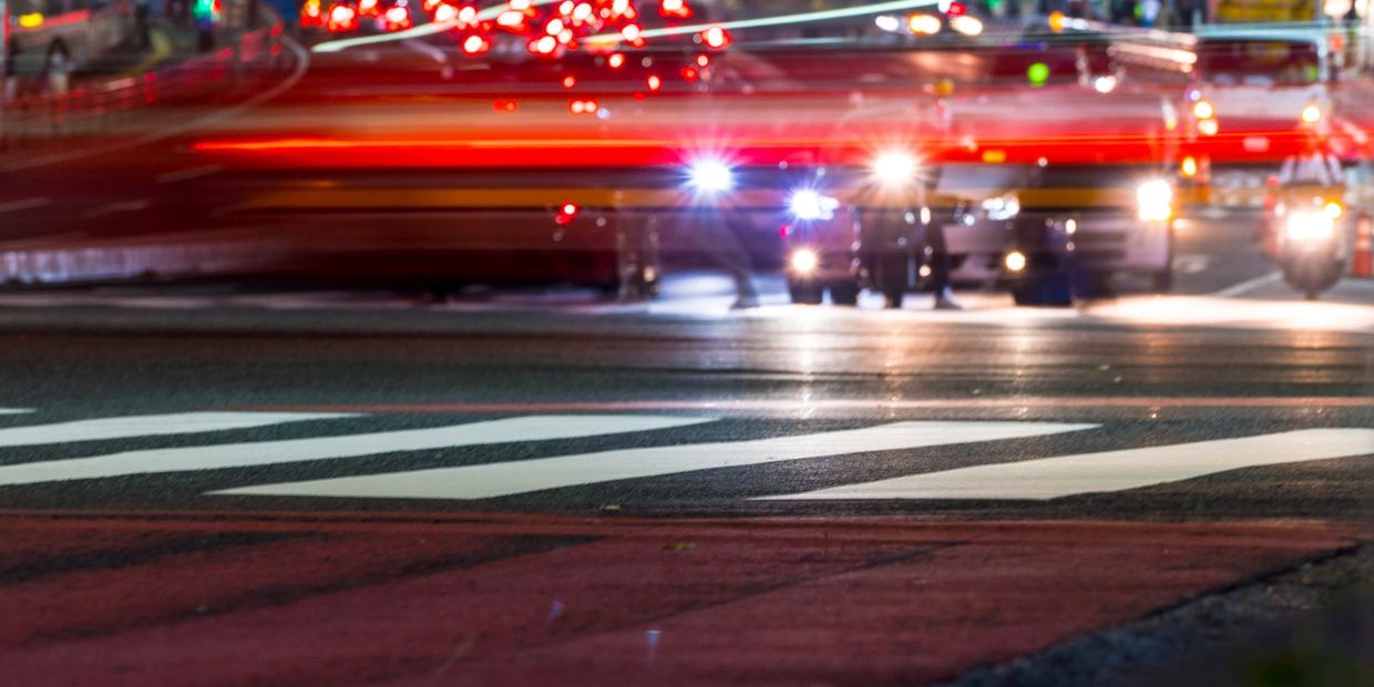 night lights in the street with vehicles in the background