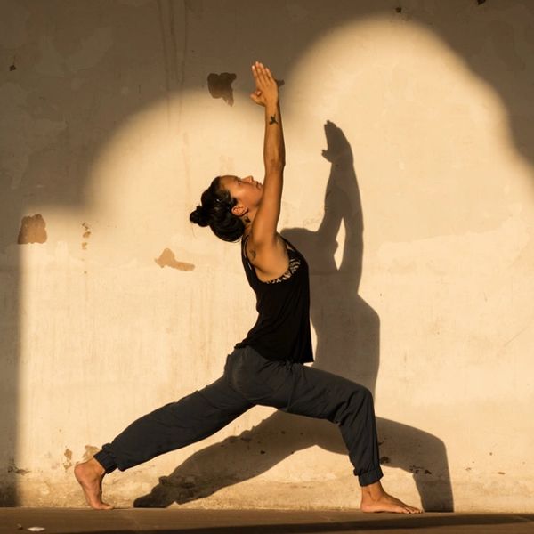Woman practicing yoga with beautiful lighting and shadow