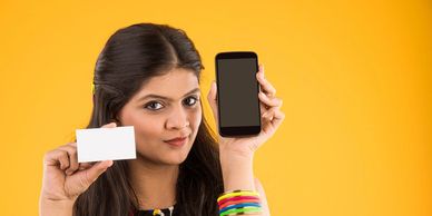 Girl holding mobile phone and membership card.