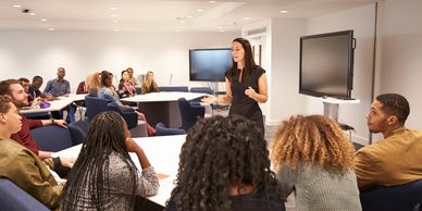 A woman teaching a group of adults