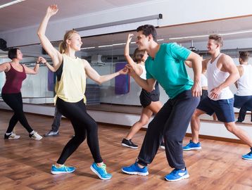 Man and woman are dancing in a studio