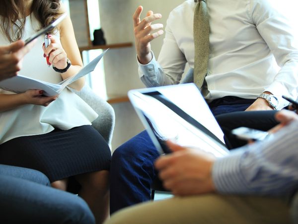 Business professionals discussing documents in a meeting.