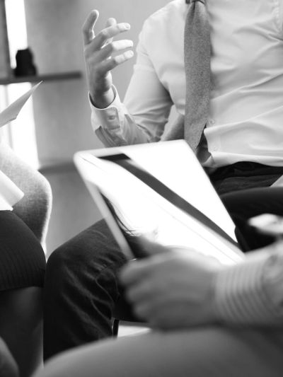 Business meeting with individuals discussing and reviewing documents.