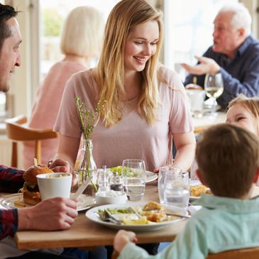 Family enjoying a meal together in a cozy restaurant.