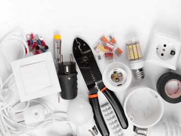 Electrical tools and components arranged on a white background.