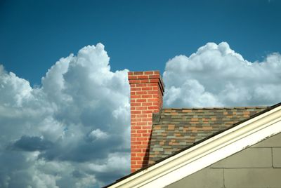 A picture of a chimney on a cloudy day, the chimney is ready for a sweep and inspection.