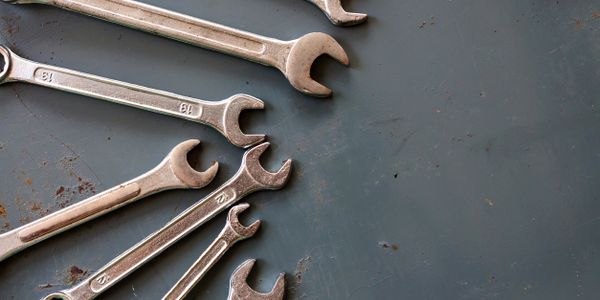 10mm 18mm 12mm 15mm Wrenches on a rusted tabletop