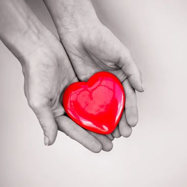 Caring hands holding a heart