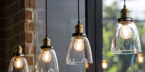 Hanging glass pendant lights installed with gold/brass color