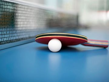 Visitors enjoying a lively table tennis match at Namooru Ecostay.