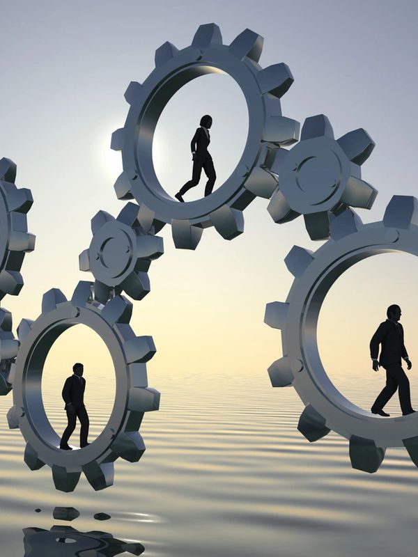 People walking inside giant gears over water, symbolizing work and routine.