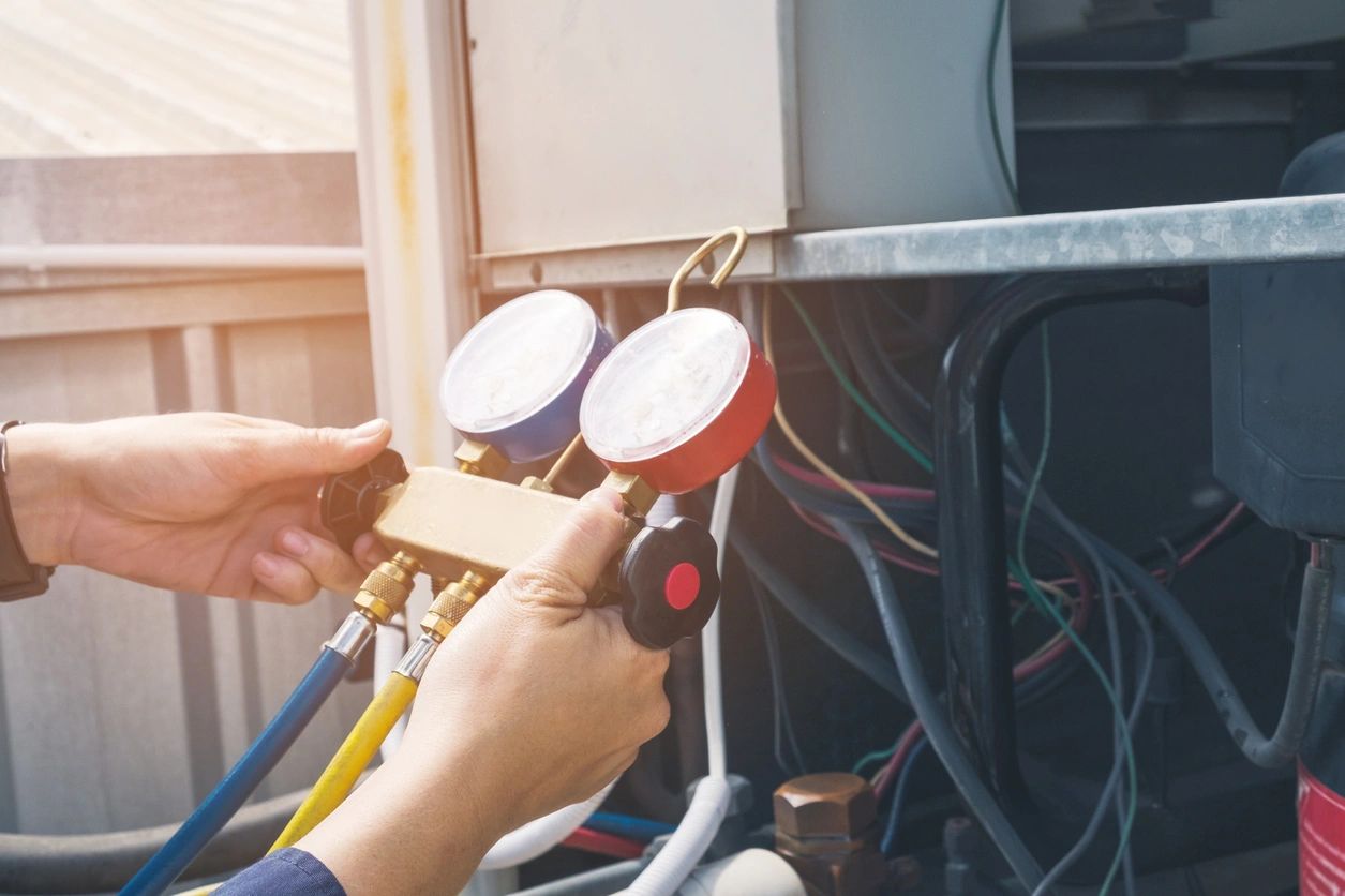 HVAC technician checking freon levels. 