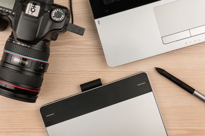 Laptop, camera, and tablet for digital arts.