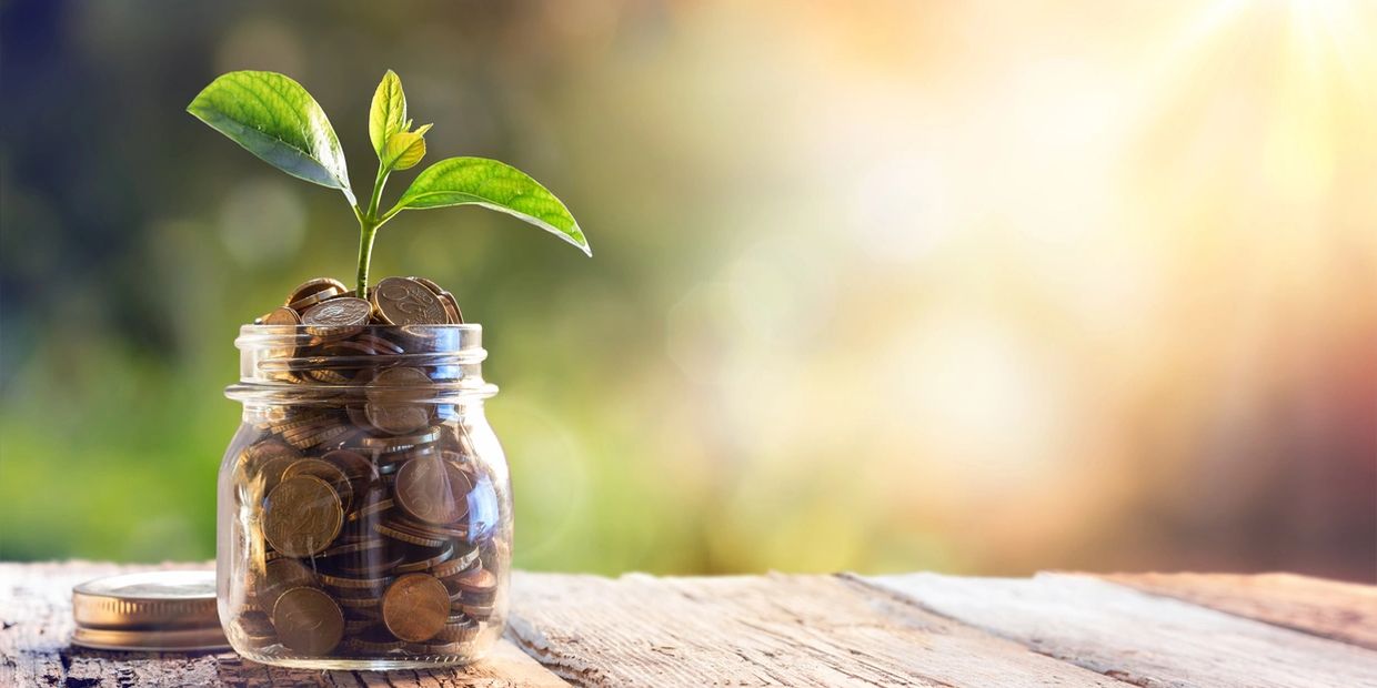 A jar of money to represent growing savings to purchase a home