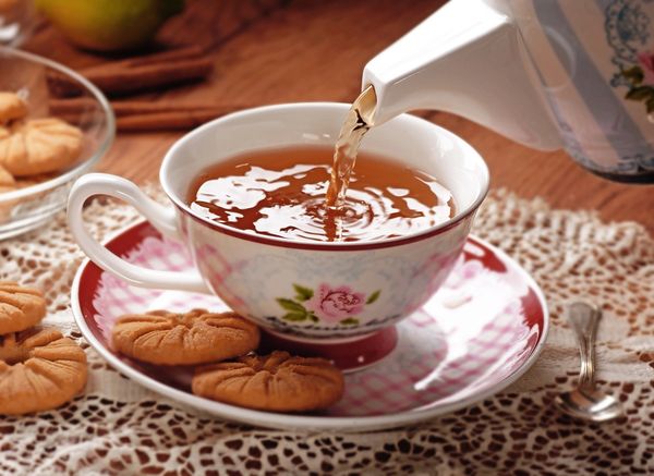 Pouring tea into a vintage teacup
