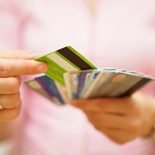 Person holding and selecting from multiple credit cards.