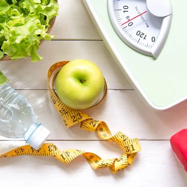 Scale apple, water bottle, dumbbell, and lettuce 