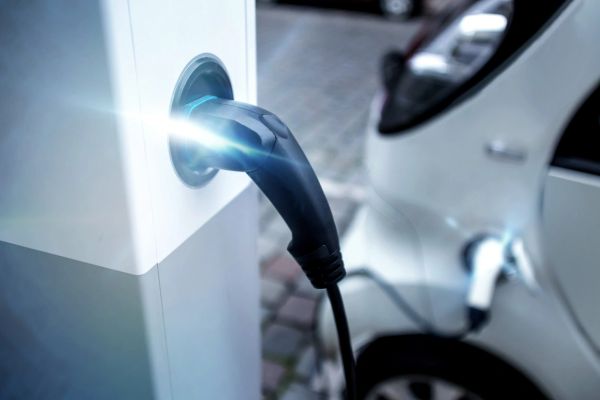 Electric car charging at a public charging station.