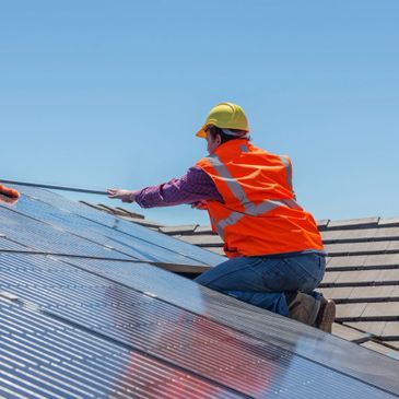 Solar maintenance crew cleaning a solar panel