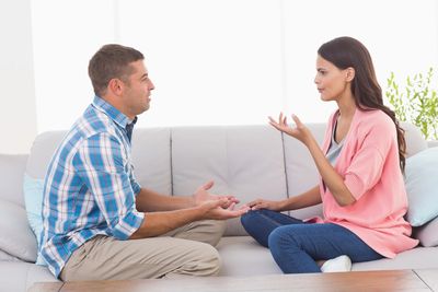 couples in marriage counseling sharing their feelings on a couch in a therapy office.
