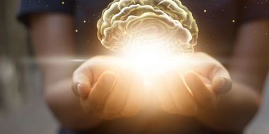 Hands holding a glowing brain, symbolizing knowledge, creativity, and the power of innovation.