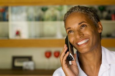 Woman smiling while talking on the phone.