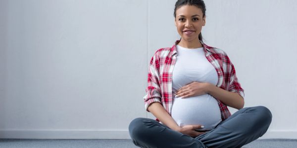 Women holding pregnant stomach 