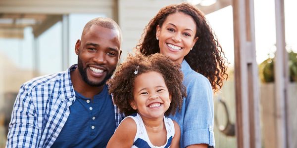 Smiling African American family, Man, Woman and child. 