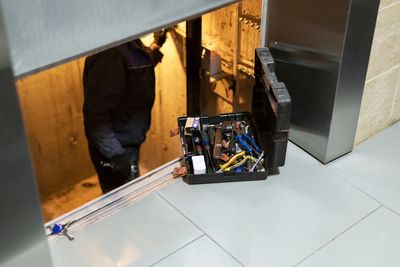 Toolbox with electronic equipment near a stairway.