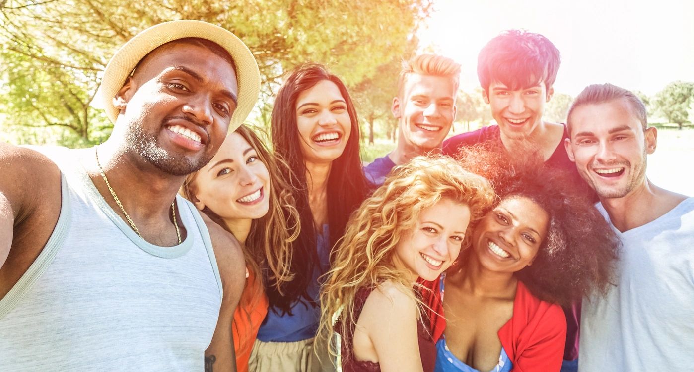 A group of friends smiling outdoors.