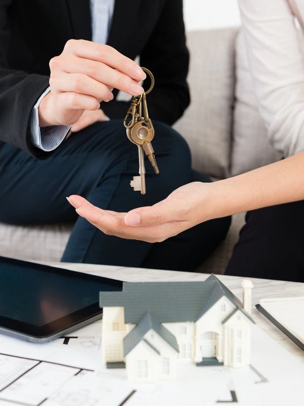 an agent handing keys over to a new buyer 