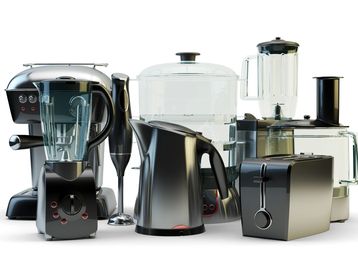 A collection of modern kitchen appliances including a blender, kettle, toaster, and food processor.