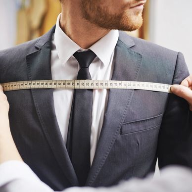 Image of person being measured for a suit.